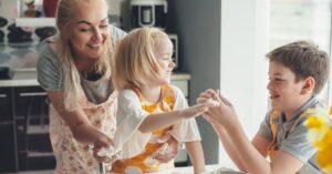 Image of mom and two children baking together.