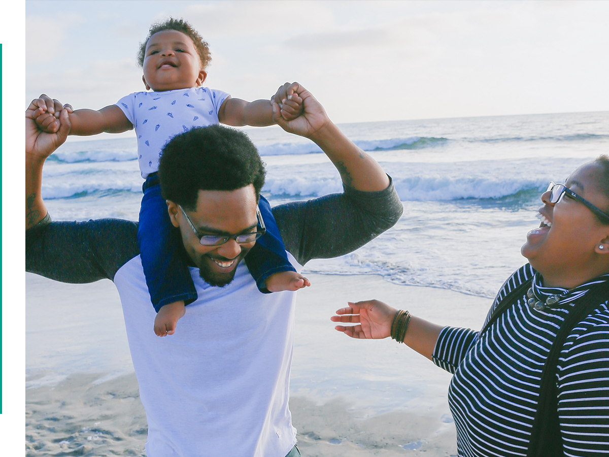 Two people playing with a toddler.