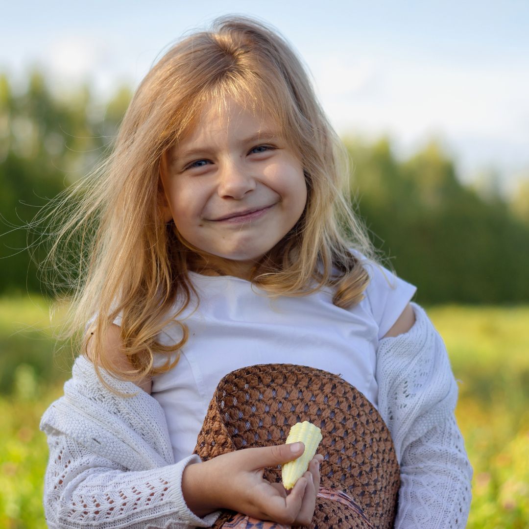 a girl holding het hat