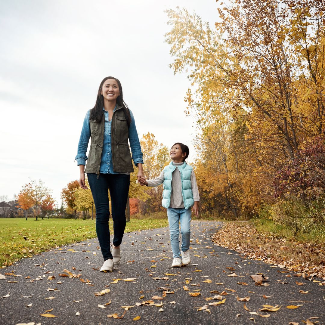 a mother walking outside with a child