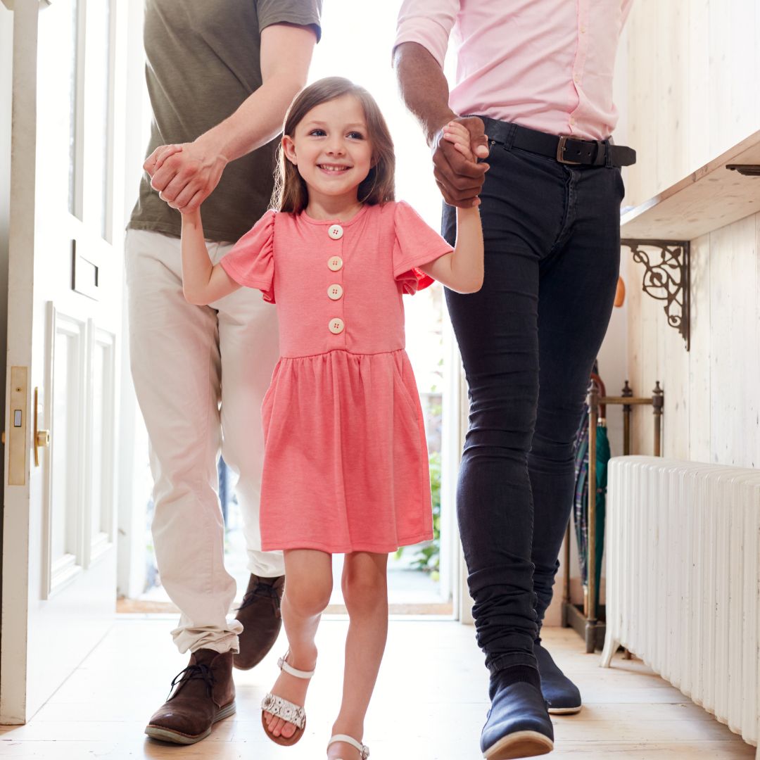 little girl being led into foster home