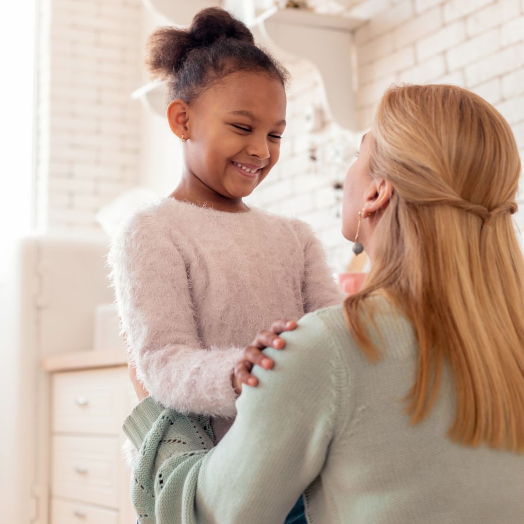 Young girl being comforted by a woman. 